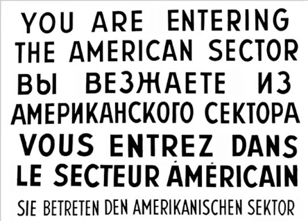 "Checkpoint Charlie" sign from Berlin, Germany. The text reads, ' YOU ARE ENTERING THE AMERICAN SECTOR' in English, Russian, French and German reflecting the 4 nations supporting Berlin after WWII,